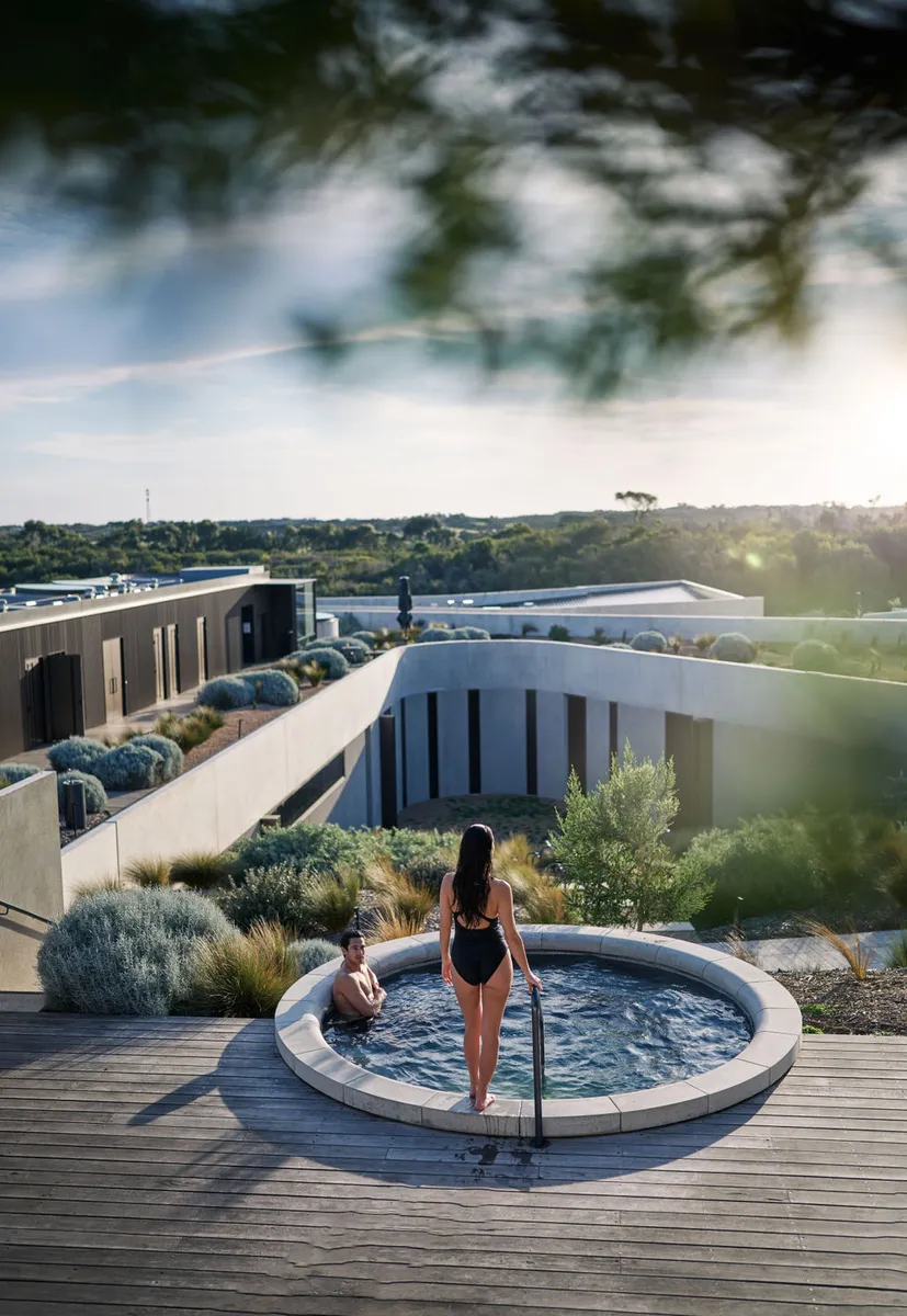 Bathers at a rooftop pool at Alba Thermal Springs, looking over the Peninsula