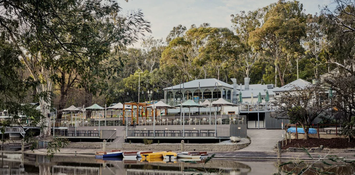 Studley Park Boathouse on the Yarra, with rowing boats moored below the deck
